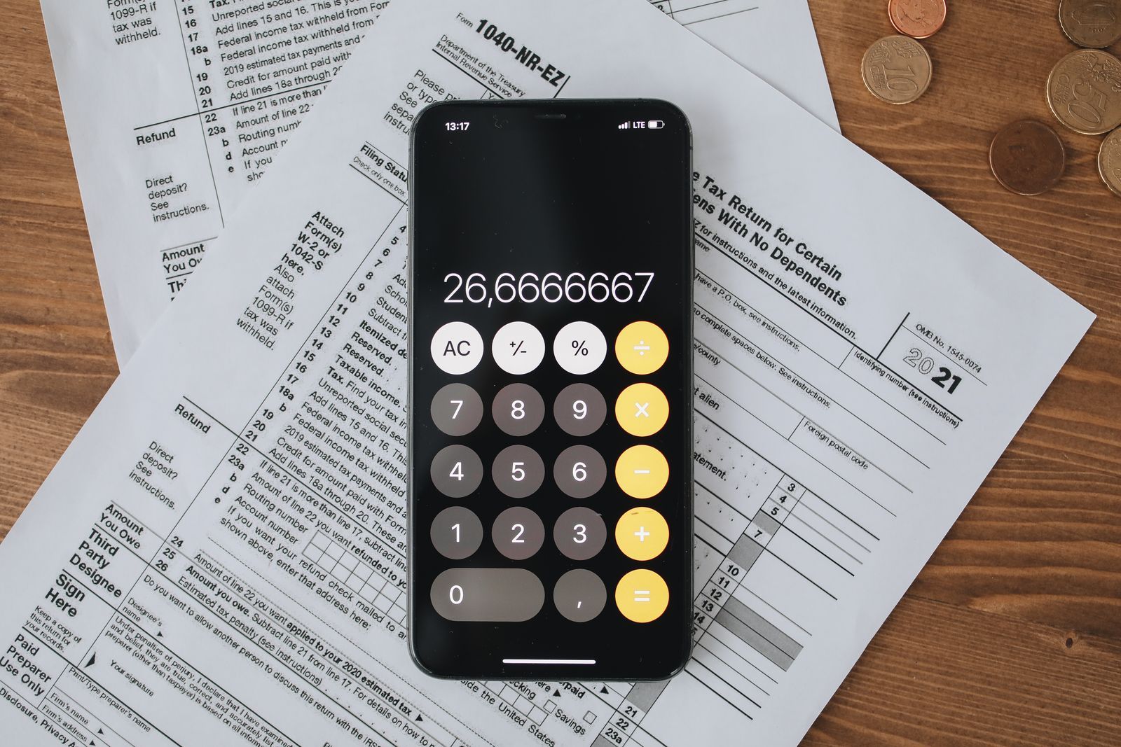 Tax forms with a calculator on a wooden desk